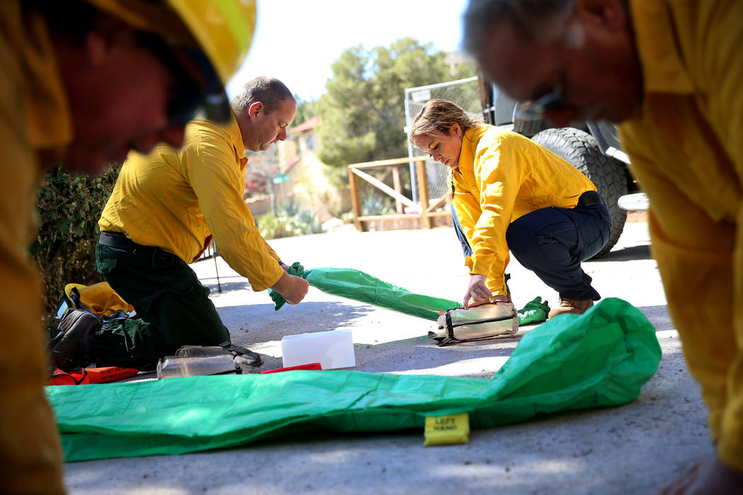 Kevin McClean, left, fire equipment technician for the Clark County Fire Department, and Heathe ...