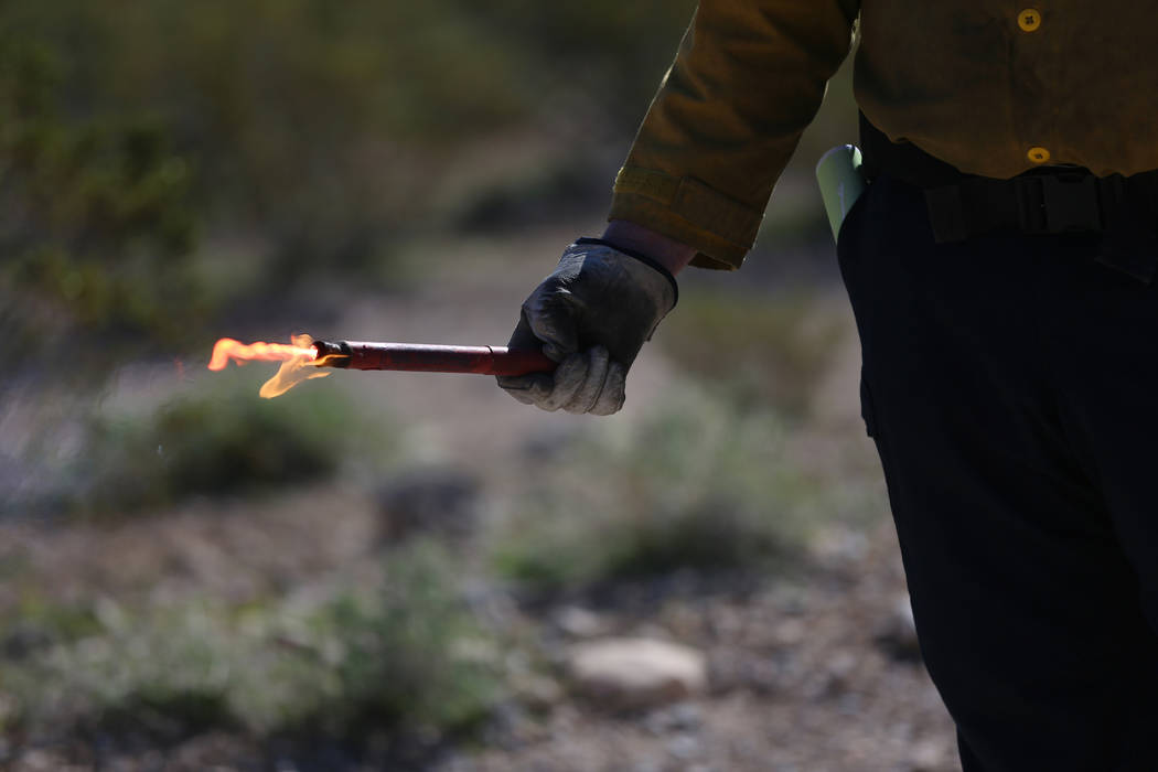 A student learns to use a fusee during a firefighter training session to helps volunteer firefi ...