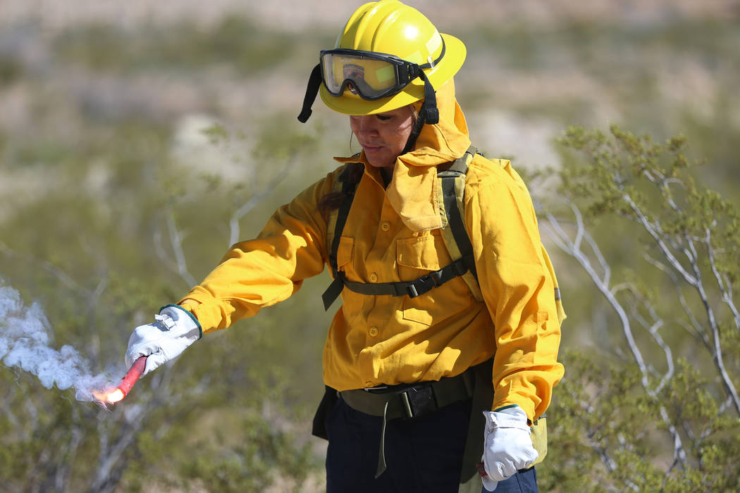 Heather Alexander, volunteer firefighter for Station 83 in Indian Springs, holds a fusee during ...