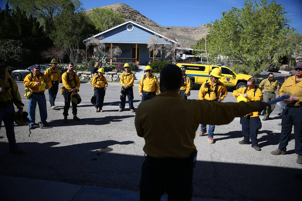 Larry Haydu, center, assistant fire chief for the Clark County Fire Department, gives instructi ...