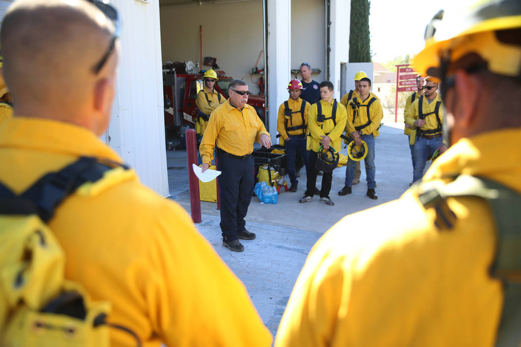 Larry Haydu, center, assistant fire chief for the Clark County Fire Department, gives instructi ...