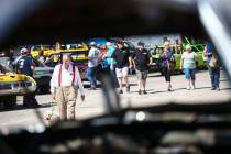 Don Mitchell, of Henderson, and his dog, Scout, walk through the pit area before the start of t ...