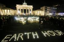 Activists of the World Wide Fund For Nature (WWF) set up led-lights in front of the illuminated ...