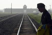 FILE - In this file photo dated Friday, July 29, 2016, a man crosses the iconic rails leading t ...