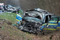 A damaged police car is seen next to a road in Langen near Frankfurt, Germany, Sunday, March 31 ...