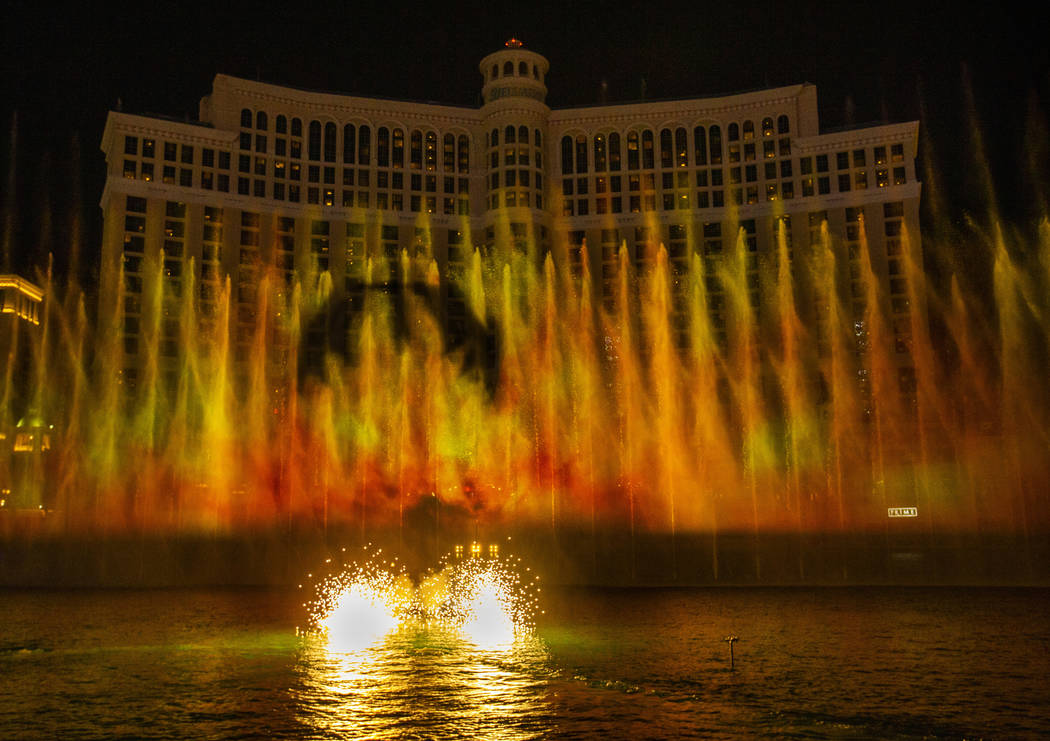 A dragon flies into the flames during the debut of the new water show based on ÒGame of Th ...