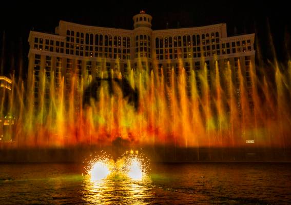 A dragon flies into the flames during the debut of the new water show based on "Game of Th ...