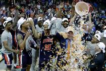 Auburn head coach Bruce Pearl is doused with confetti after the Midwest Regional final game aga ...