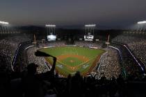 FILE - In this Oct. 27, 2018, file photo, fans cheer from the top of Dodger Stadium during Game ...