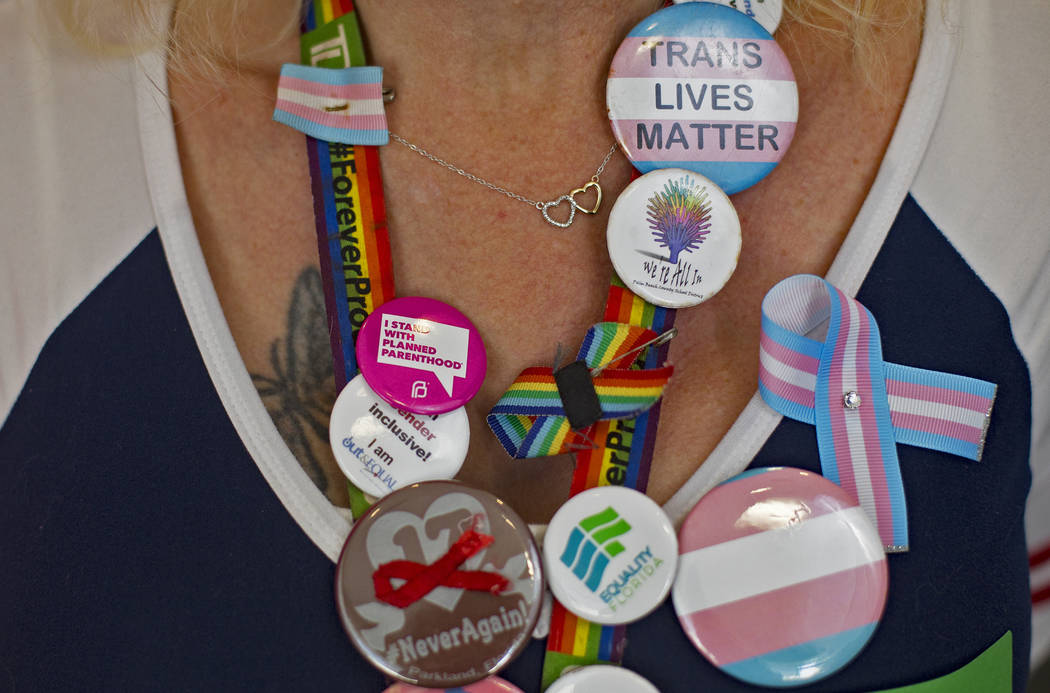 Samantha Palaggi shows off buttons collected from across the United States at the Trans Day of ...