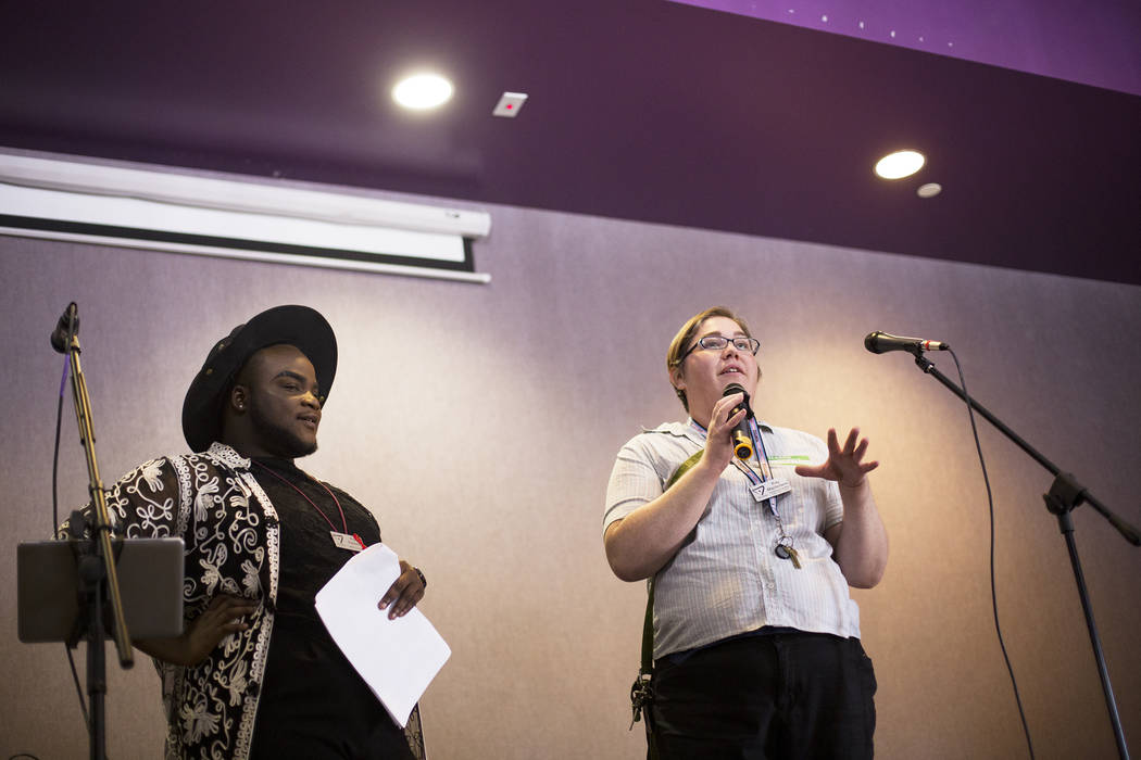 Ray Macfarlane, the trans & gender diversity program manager, speaks to the crowd next to h ...