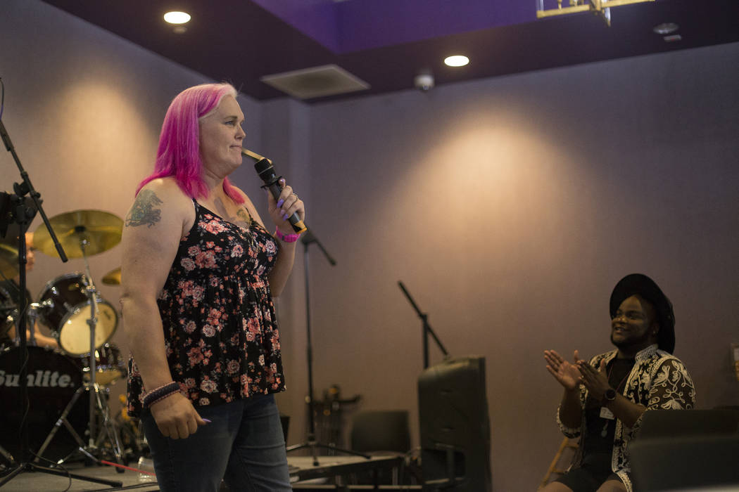 Rachel Rogers speaks to the crowd next to host Rio Perkins at the Trans Day of Visibility event ...