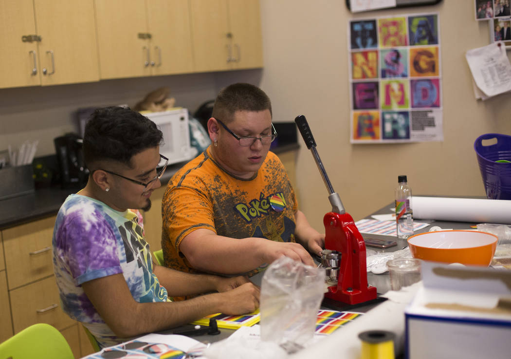 Jose Martinez, left, works with Michael Limon to make buttons at the Trans Day of Visibility ev ...