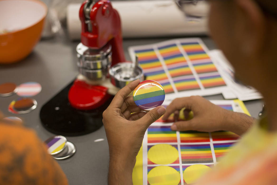 Michael Limon, left, works with Jose Martinez to make buttons at the Trans Day of Visibility ev ...