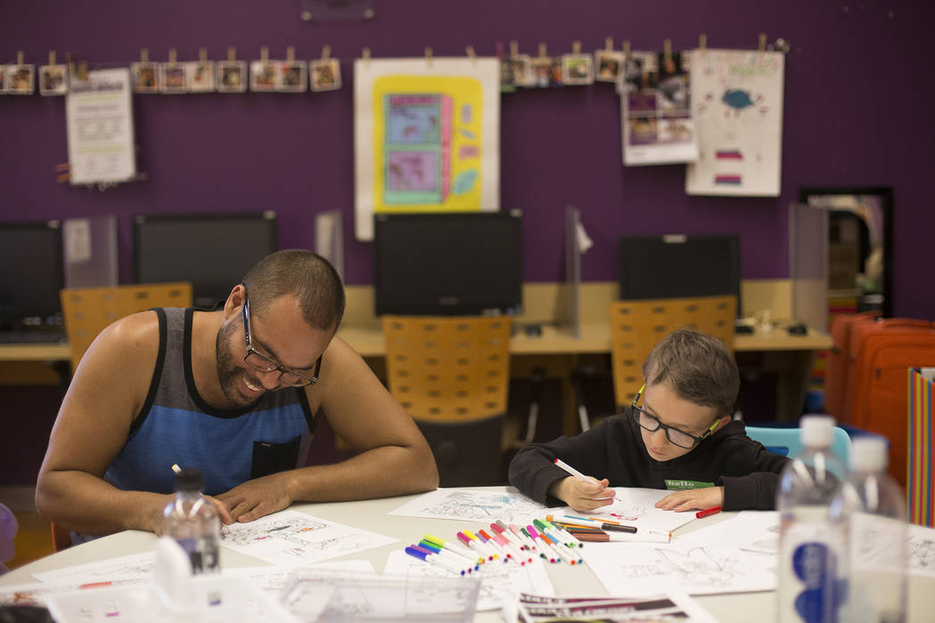 Joe Sheperd draws with Sterling Gylstorff, 8, at the Trans Day of Visibility event at The Cente ...