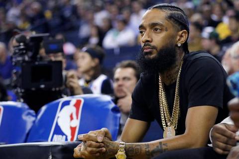 Rapper Nipsey Hussle watches an NBA basketball game between Golden State and Milwaukee in Oakla ...