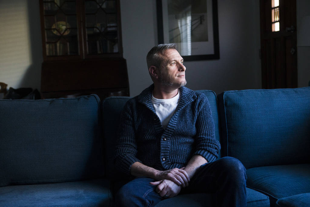 Jim Foley, who was diagnosed as HIV positive 30 years ago, poses for a portrait at his home in ...