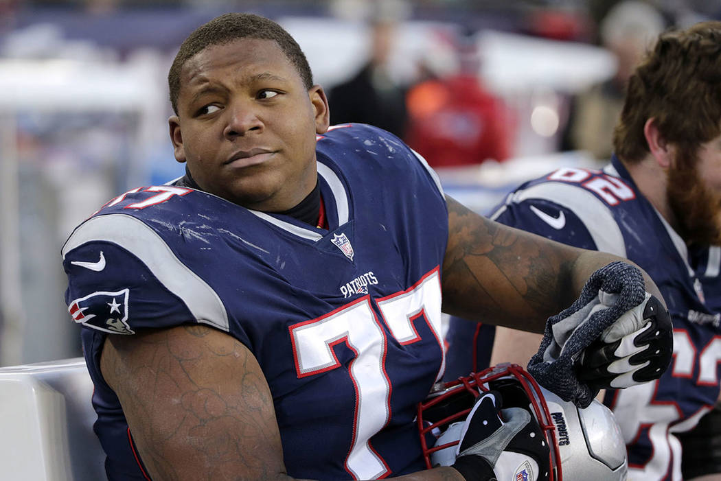 New England Patriots tackle Trent Brown sits on the sideline during a game against the Buffalo ...