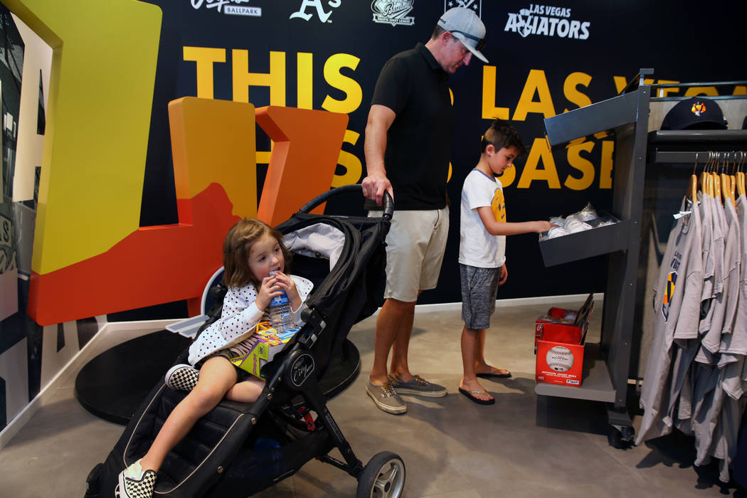 Lola Baker, 4, hangs out as her father Brian and brother Max, 9, of Salt Lake City, Utah, check ...