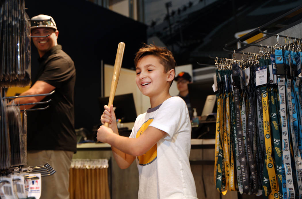 Max Baker, 9, of Salt Lake City, Utah, swings a small baseball bat at the Las Vegas Aviators sa ...