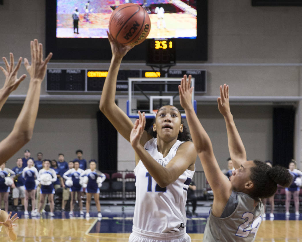 Centennial junior Aishah Brown (12) shoots a jump shot over Bishop Gorman junior Bentleigh Hosk ...