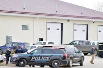 Mandan, N.D., Police Deputy Chief Lori Flaten, left, and other law enforcement personnel stand ...