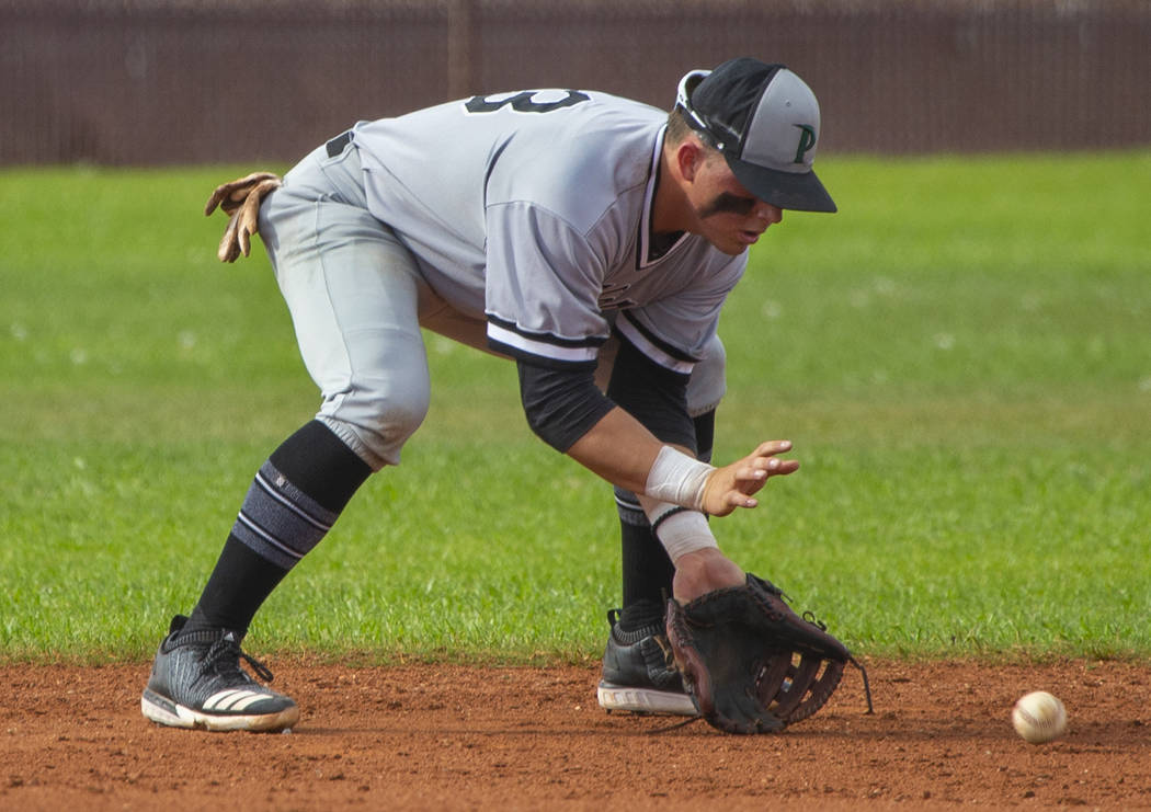 Palo Verde's Paul Myro IV (23) scoops up a grounder from a Faith lutheran batter during their h ...