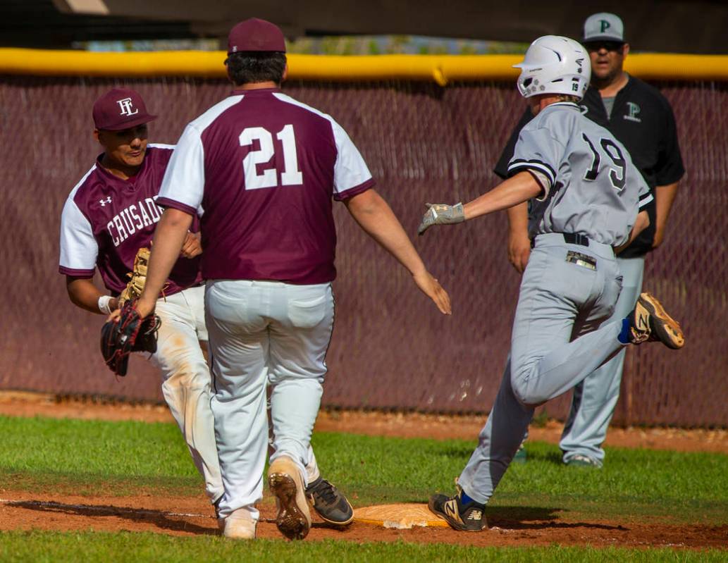 Faith Lutheran's Jacob Ortega (8) gets back to first base for the out before Palo Verde runner ...