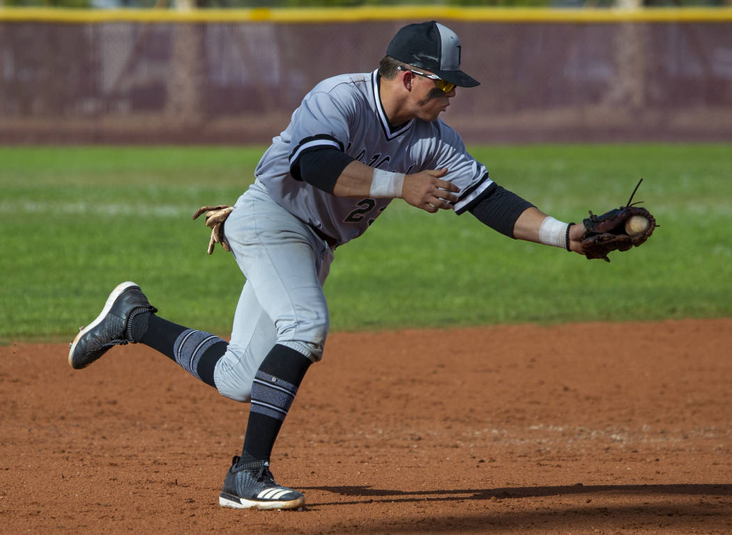 Palo Verde's Paul Myro IV (23) scoops up a grounder from a Faith lutheran batter during their h ...