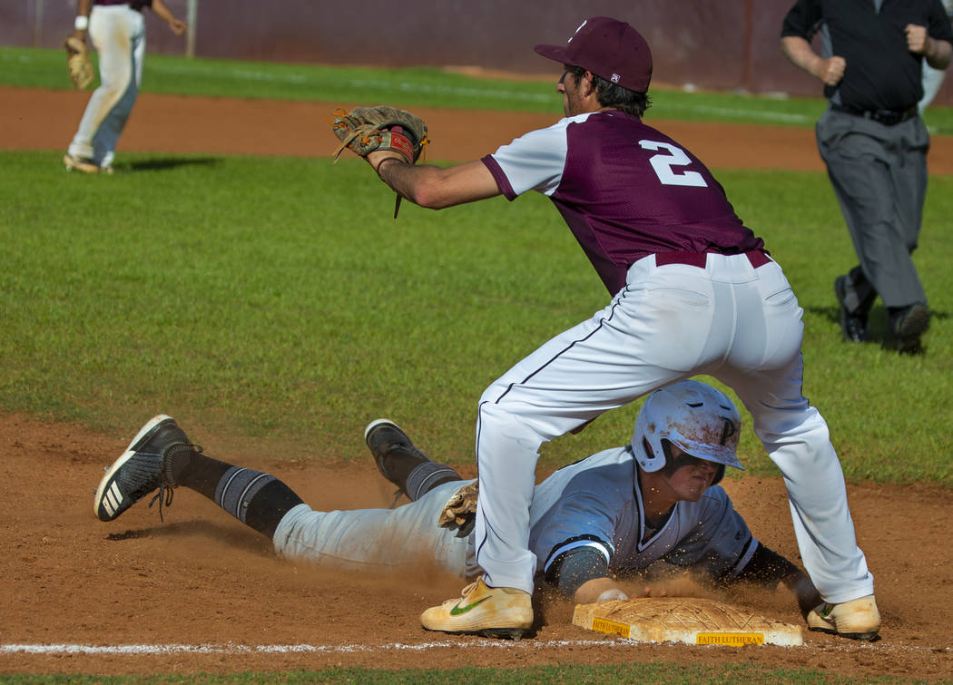 Palo Verde's Paul Myro IV (23) dives to tag third base ahead of a throw to Faith Lutheran's Mic ...