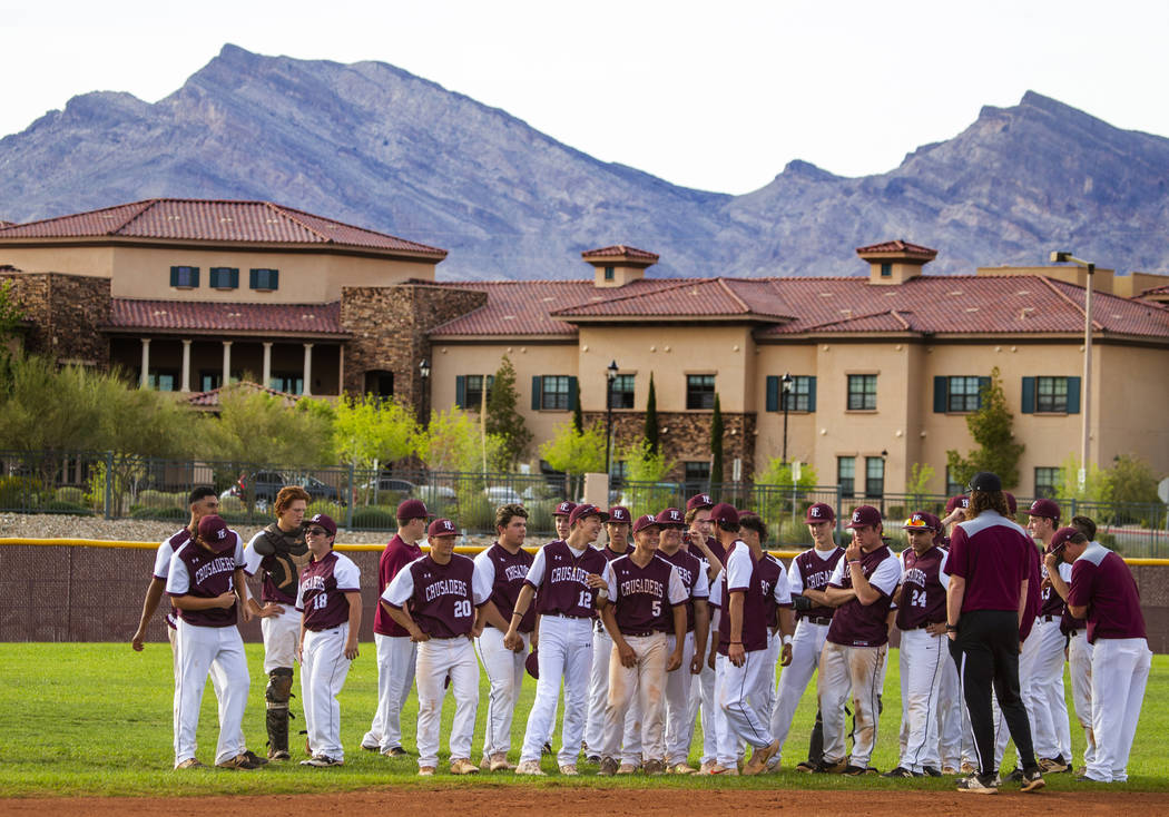 Faith Lutheran players come together and celebrate their win over Palo Verde during their high ...