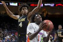 Bishop Gorman sophomore guard Will McClendon (1) drives past Clark senior guard Carlos Allen (4 ...