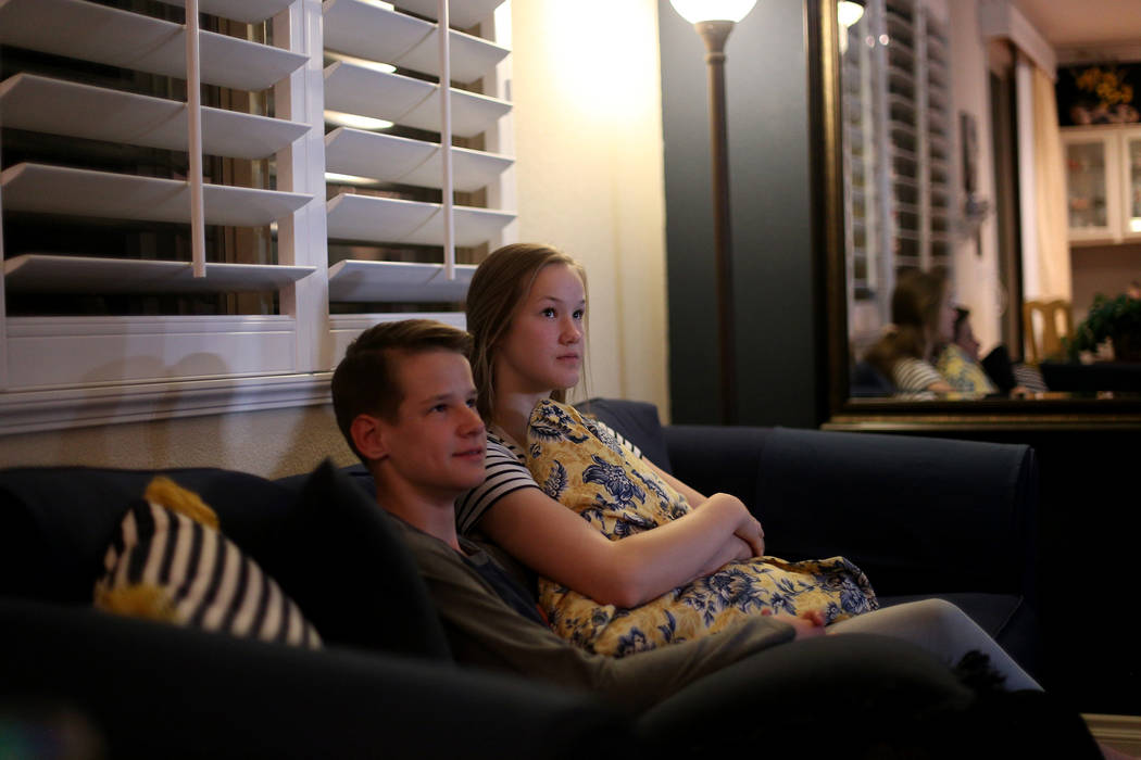 Isaiah Warner, 12, left, and Hannah Warner, 15, at the watch party for their grandfather George ...