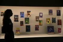 A member of British Library staff poses Oct. 18, 2017, for a picture with Harry Potter books pu ...
