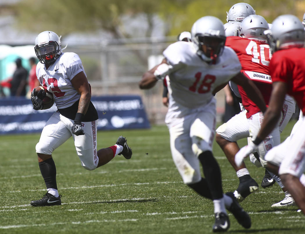 UNLV Rebels running back Tariq Hollandsworth (13) runs the ball during the spring football game ...