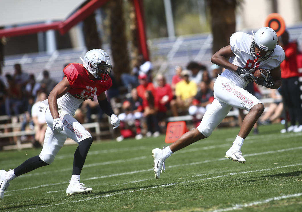 UNLV Rebels defensive back Demitrious Gibbs, left, chases after wide receiver Andre Collins Jr. ...