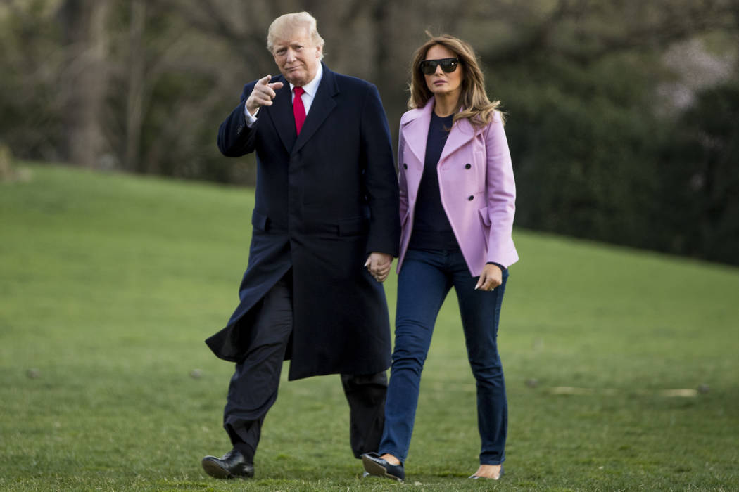 President Donald Trump and first lady Melania Trump walk along the South Lawn of the White Hous ...
