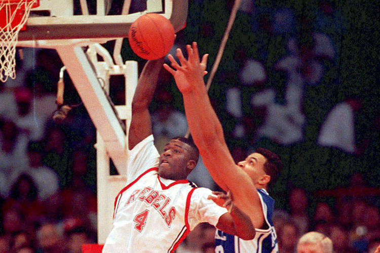 UNLV basketball forward Larry Johnson gets off shot beyond the defensive reach of Duke's Alaa A ...