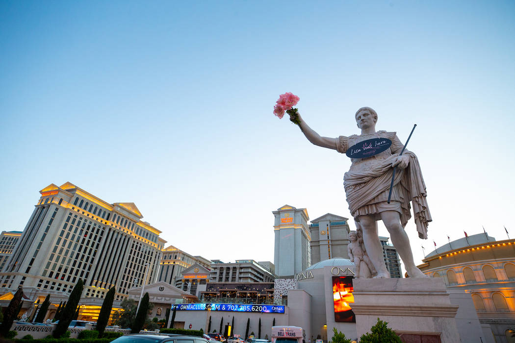 Caesars Palace's Roman statue on the Las Vegas Strip holds pink flowers in celebration of Lisa ...