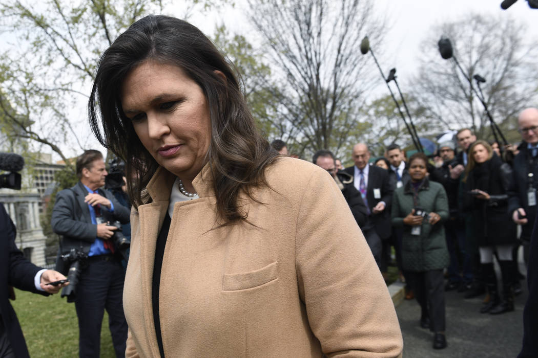 White House press secretary Sarah Sanders turns to go back into the White House in Washington a ...