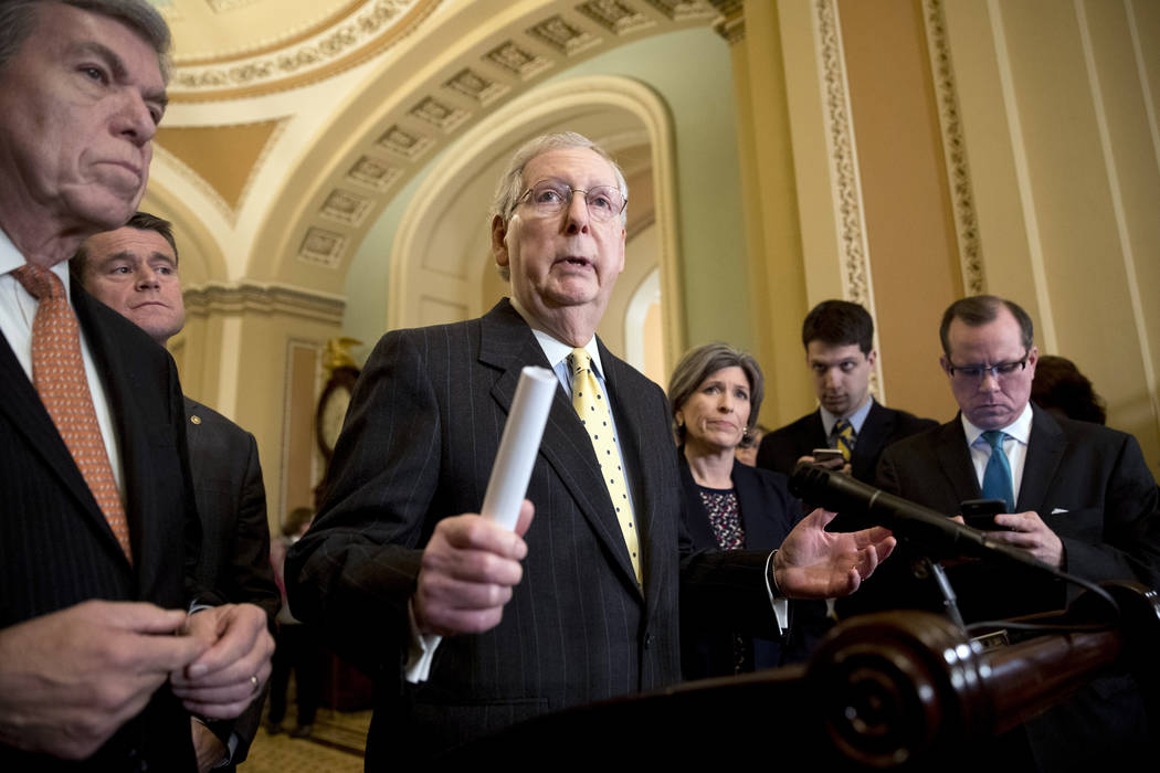 Senate Majority Leader Mitch McConnell of Ky., accompanied by Sen. Roy Blunt, R-Mo., left, Sen. ...
