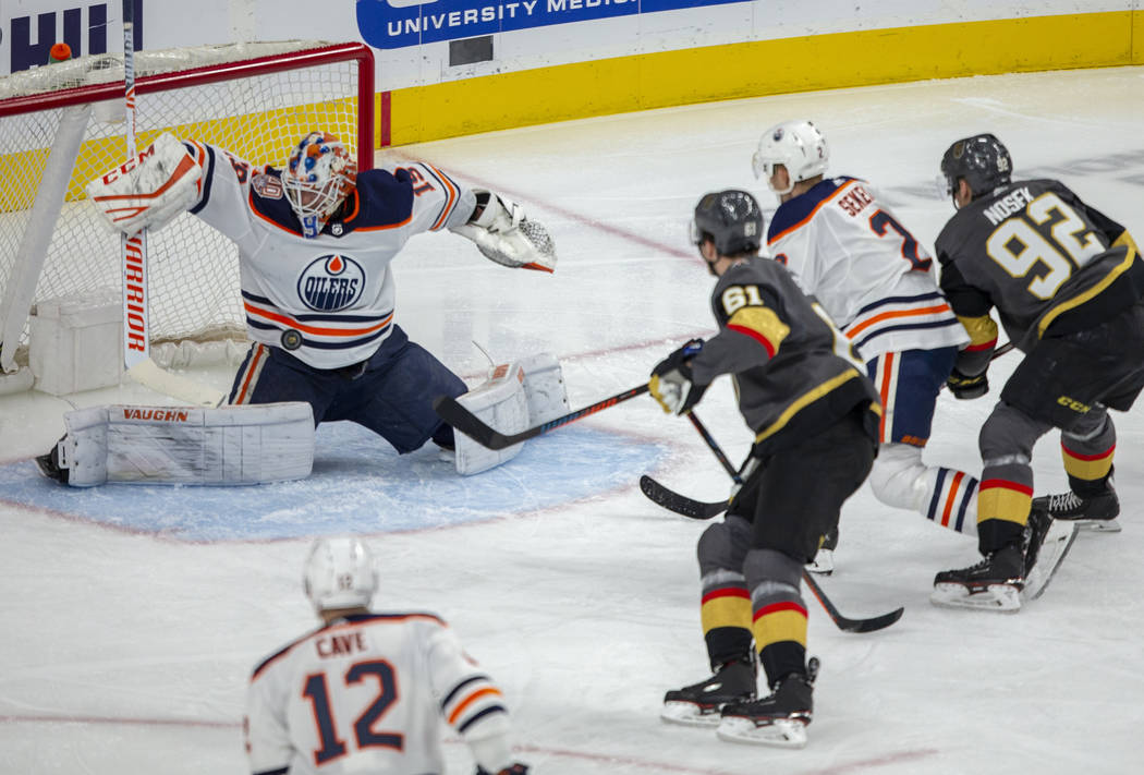 Edmonton Oilers goaltender Mikko Koskinen (19) takes a puck to the chest as Vegas Golden Knight ...