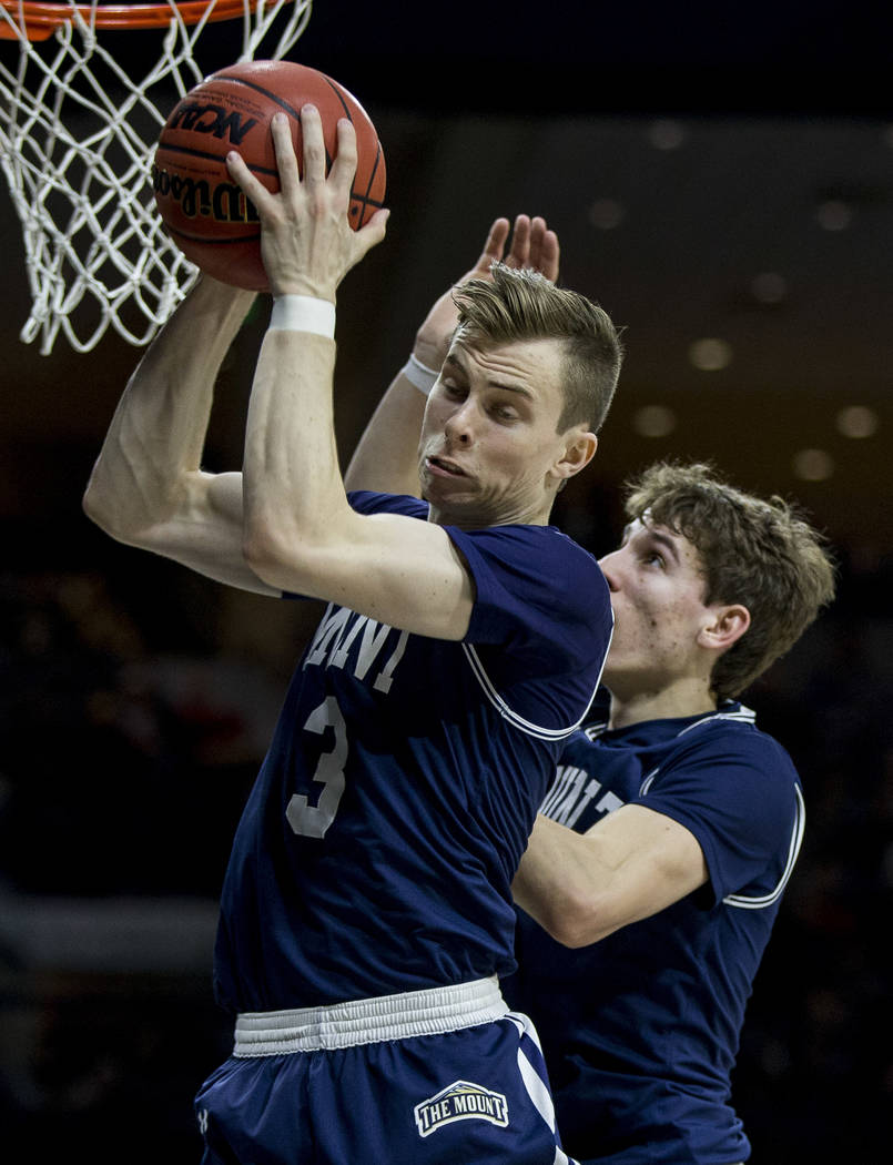 Mount St. Mary's Jonah Antonio (3) grabs a rebound in front of teammate Bobby Planutis during t ...