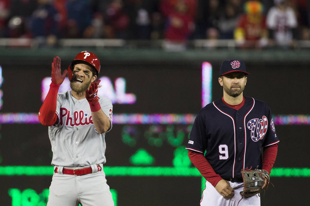 Philadelphia Phillies' Bryce Harper, left, celebrates his RBI hit while on second base with Was ...