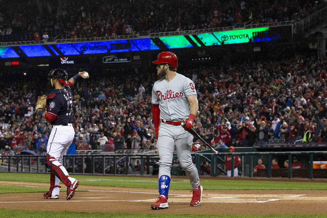 Philadelphia Phillies' Bryce Harper walks to the dugout after striking out during the first inn ...
