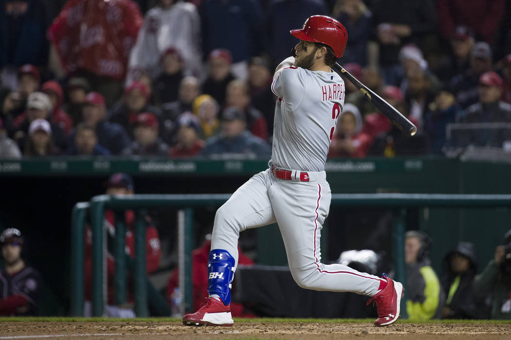 Philadelphia Phillies' Bryce Harper watches his double during the fifth inning of a baseball ga ...