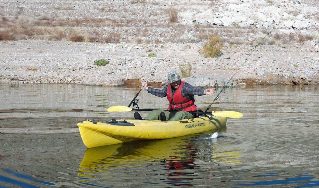 Hyrum Nielsen pulls in a Lake Mead catfish while fishing from a kayak. Notice the simple riggin ...