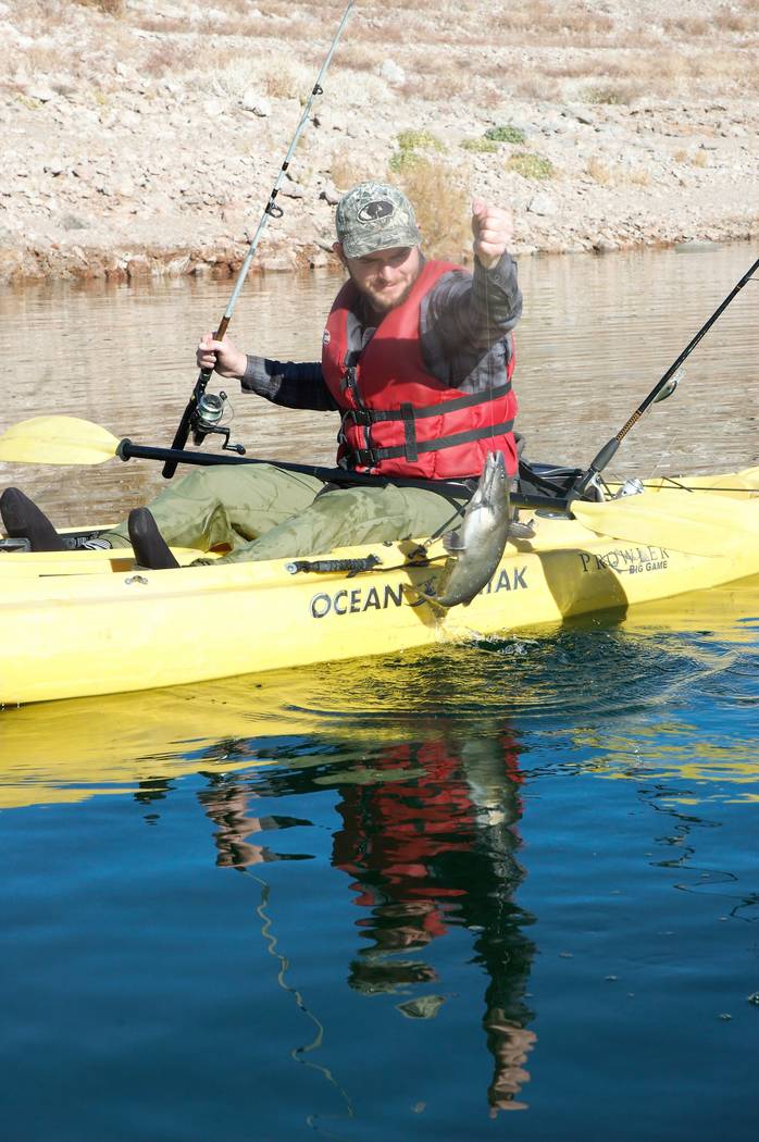 Hyrum Nielsen pulls in a Lake Mead catfish while fishing from a kayak. Notice the simple riggin ...