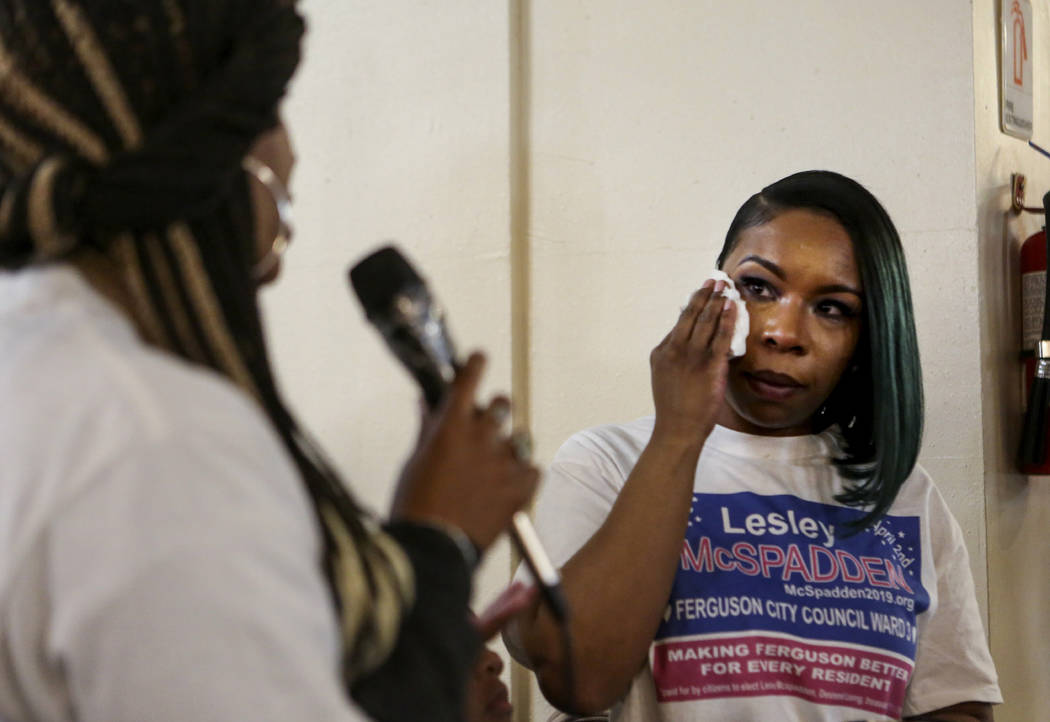 Lesley McSpadden wipes away tears as co-campaign manager Rukia Lumumba speaks during McSpadden' ...