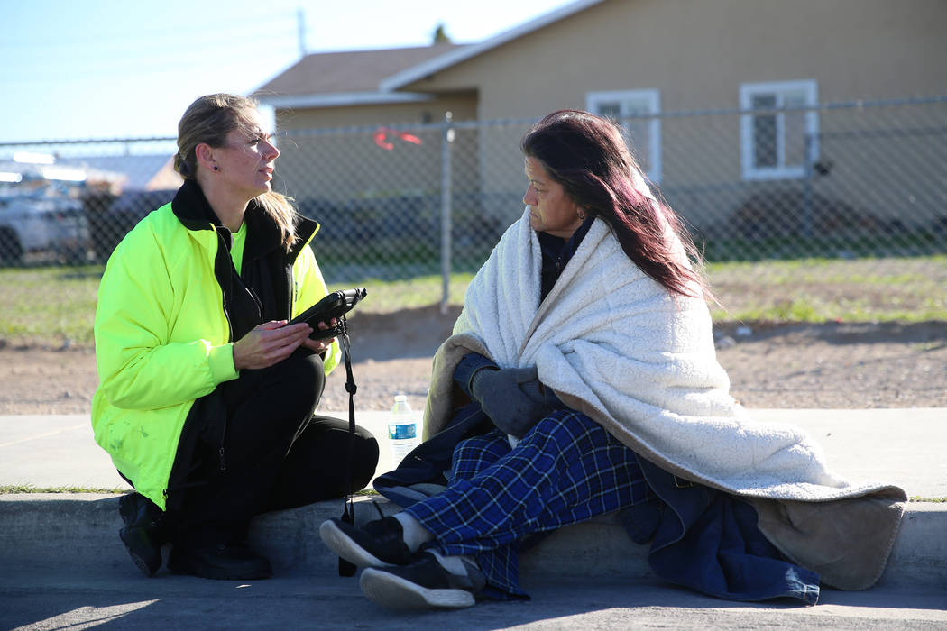 Talana Bell, left, case manager for WestCare, talks to homeless woman Sherri Fox about program ...